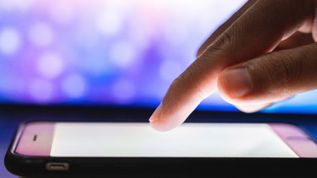 Close up finger touching smart phone.の写真素材