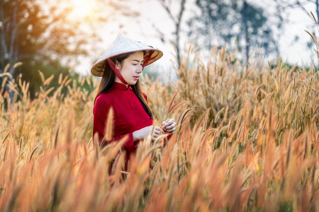 Asian woman wearing Vietnam culture traditional in african fountain flower field.の写真素材