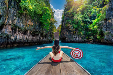 Beautiful girl in red bikini on boat at Koh hong island, Thailand.の写真素材