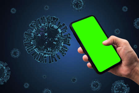Hand holding smartphone and Covid-19, coronavirus, 3D virus render on background.の写真素材