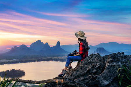 Tourist sitting on Phu sub lek viewpoint at sunset, Lopburi, Thailand.の写真素材