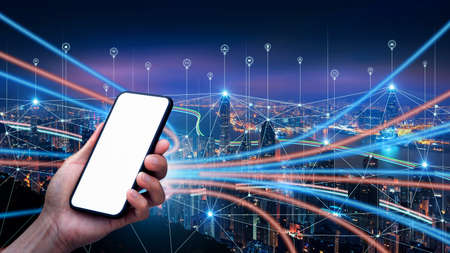 Male hand holding smartphone with blank screen and Smart connection network system background, smart city network concept, 5G wireless connection.の写真素材