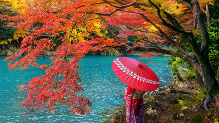 Asian woman wearing japanese traditional kimono at Arashiyama in autumn season along the river in Kyoto, Japan.の写真素材