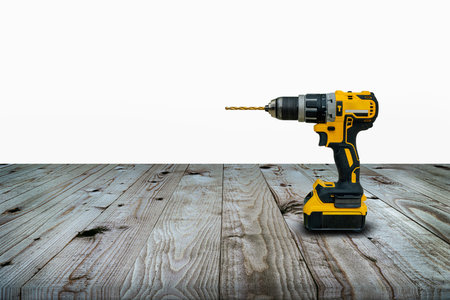 Power drill or Cordless screwdriver with battery for professional work in wooden background.の写真素材
