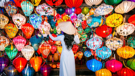 Asian woman wearing vietnam culture traditional and hoi an lanterns at Hoi An ancient town, Vietnam.の写真素材