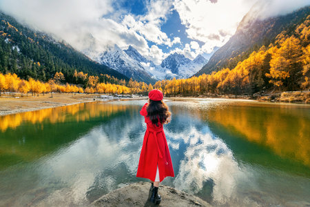 Tourist taking photo of Bipenggou in autumn, Chengdu in China.