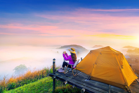Tourist taking a photo and enjoy nature panoramic landscape at foggy over mountain, Chiang mai, Thailand.の写真素材