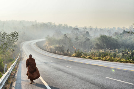 monk is walking on road,Thailand
