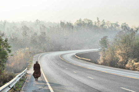 monk is walking on road,Thailandの写真素材