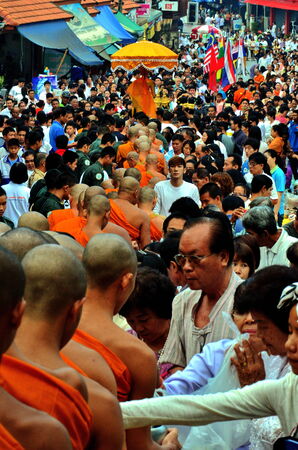 Stock Photo - Chiang Mai,Thailand - In the Buddhist Lent, rituals are great. The priest filed per row, together many early in the morning, then there will be people of the food put in a bowl.のeditorial素材