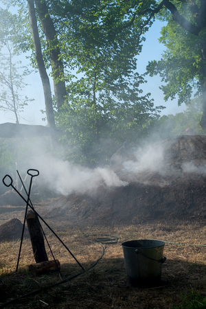 The constant treatment of the kiln fire ensures the success of charcoal production.の写真素材