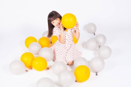 kid play gold and silver balloonsの写真素材
