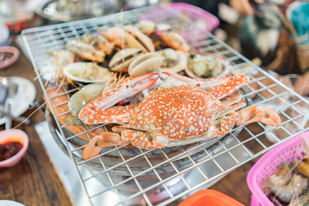 Grilled crab on flaming grill - selective focusの写真素材