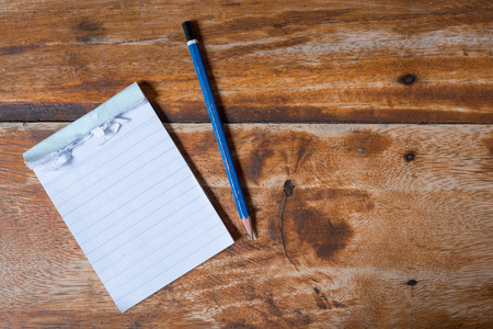 note book pencil on old wood table