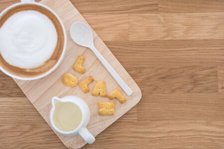 Cup of coffee and biscuit on wooden tableの写真素材