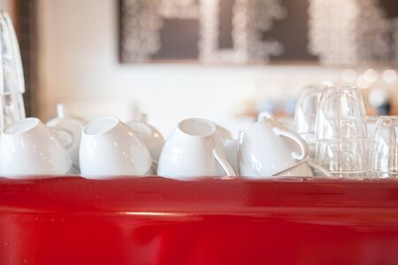 white cups on red shelfの写真素材