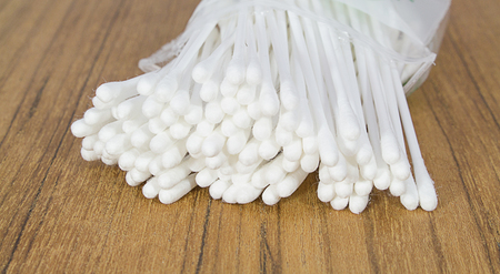 Cotton spinning ear on a wooden tableの写真素材