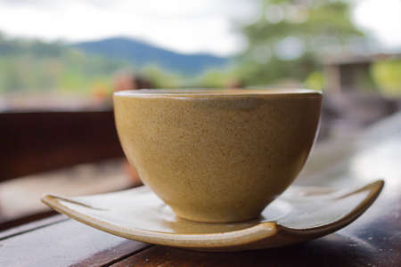Cup of coffee on  wooden table. morningの写真素材