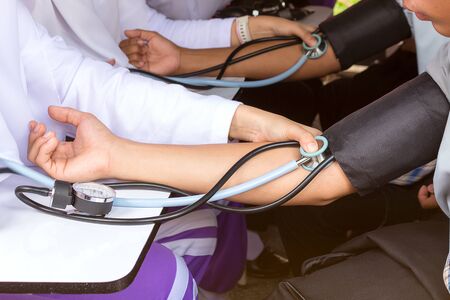 Midsection of man checking blood pressure
