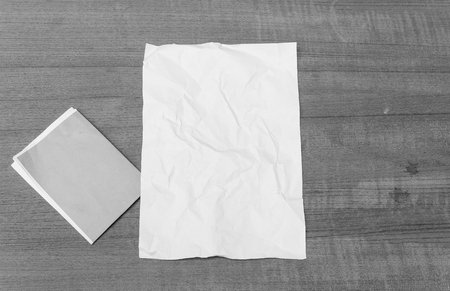 abstract Monochrome, White paper sheet, paper crumpled on a wooden floorの写真素材