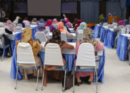 Blur blurred abstract of university students sitting in a lecture room with Movie screen , education high school, technology and people concept : Blurry view from back of the classroom :の写真素材