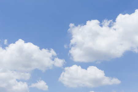 Blue sky is covered by white clouds and raincloud (may be used as background)の写真素材