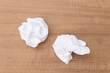 White paper sheet, paper Crumpled paper ball, on a wooden floor soft-focus  :Ideal use for background:の写真素材