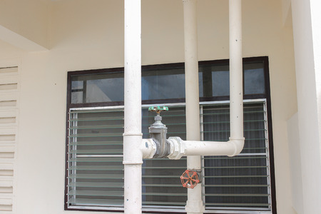 Water valve, The rust Water valve, and pipe outside building.の写真素材