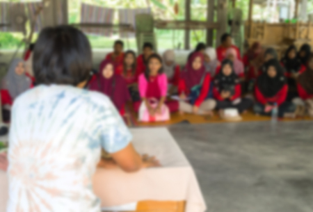 Blurred abstract background of university students sitting in a lecture room with teacher of the out Community education: Blurry view from back of the classroom: Teachers dayの写真素材