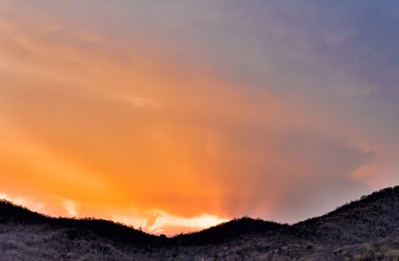 Silhouette Mountain, blue and orange in the evening sky. and motion fluffy cloud episode sunset beautiful nature : you may be used as background :の写真素材