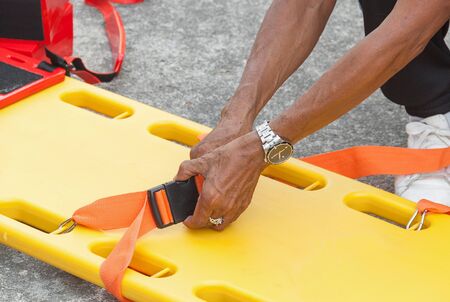 physician yellow stretcher readiness medical equipment. assist patient in emergency rescue situations.(select focus front hand physician and soft-focus background)の写真素材