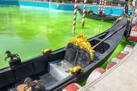 Gondolas moored by harbor, seat focus on the gondola.の写真素材