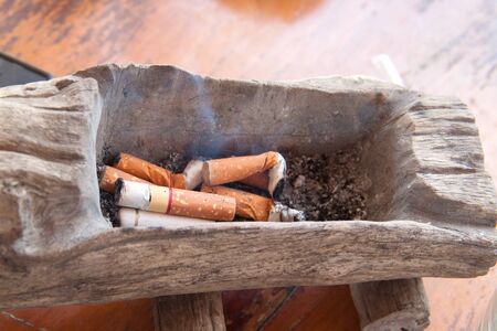 select focus  Ashtray and cigarettes and soft-focus,Smoking is also not completely extinguish the smoke. Blur backgroundの写真素材