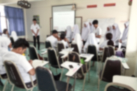 blur Blurred abstract background of university students sitting in a lecture room with  front of the class with white projector slide screen: Blurry view from back of the classroom: Teachers dayの写真素材