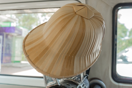 bamboo hat ,One brown hat Hanging in the car vintage retro pastel style. (select focus front bamboo hat)の写真素材