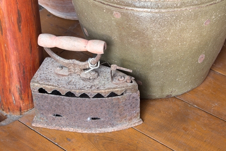 Ancient charcoal iron with  filter effect retro vintage style : Iron and ironing by using traditional coal burning heat : blurred background : select focus front charcoal iron.の写真素材