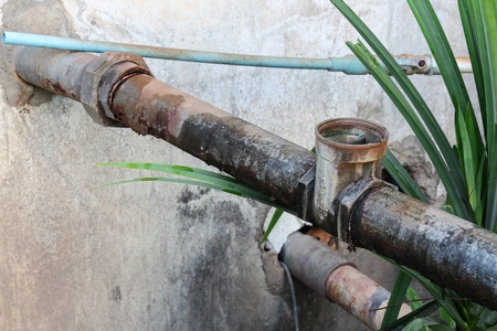 Water valve Plumbing Steel dilapidated. old rusty industrial tap water pipe. Dirty drinking water pipeline . Select focus Water valve dilapidated.の写真素材