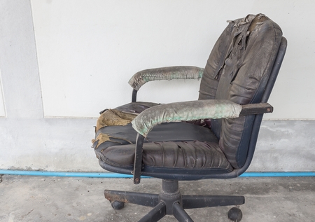 Black Office chair old damage leather and dirty, time to replace office chair.(select focus front black Office chair) :Close up,select focus with shallow depth of field.の写真素材