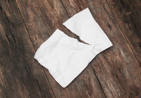 White paper sheet, The paper note rip and crumpled on a wooden floor soft-focus : with copy space for add text above and may be used as background :の写真素材