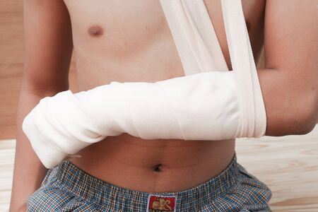 Bandage elastic. Pain and injury concept. Young man holds bandaged hand. Injured part of body. Medicine and healthcare.の写真素材
