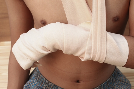 Bandage elastic. Pain and injury concept. Young man holds bandaged hand. Injured part of body. Medicine and healthcare.の写真素材