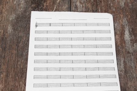 White paper sheet, paper note on a wooden floor soft-focus :  with space for add text above and may be used as background :の写真素材