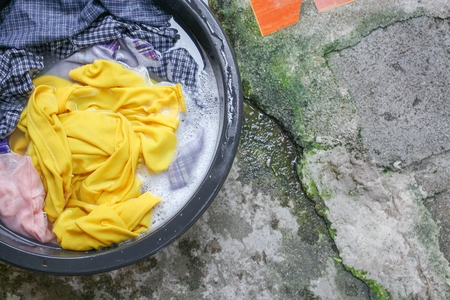 Soak dirty clothes in the basin black for clean ,Thailand washing clothes style ancient and soaking...