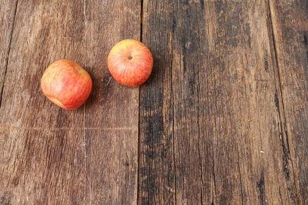 Red Apple on wooden background, top view with copy space.の写真素材