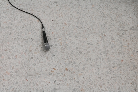 Microphone dynamic with its cable on floor marble polished stone backgroundの写真素材