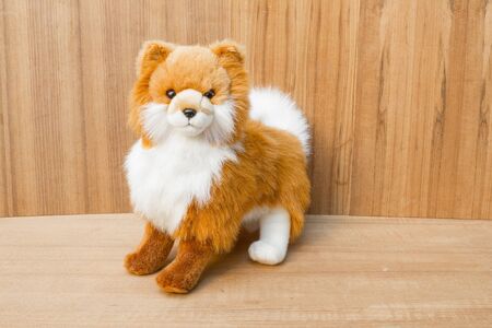 doll dog  toy cute beautiful on wooden floor backgroundの写真素材