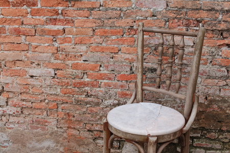 chair ancient  in the old brick wall.の写真素材