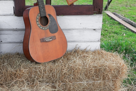 Guitar on straw in wall home background with copy space.の写真素材