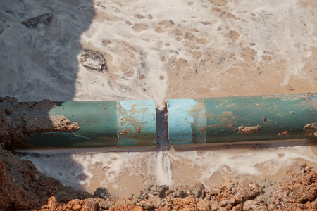 repair the plumbing broken pipe and water flow in hole.の写真素材