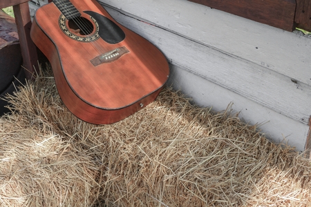 Guitar on straw in wall home background with copy space.の写真素材
